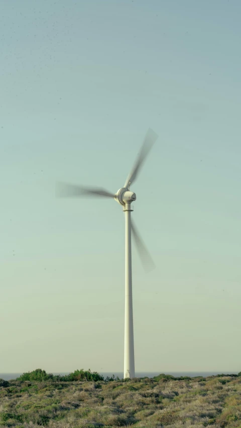 a large windmill that is in the middle of a field