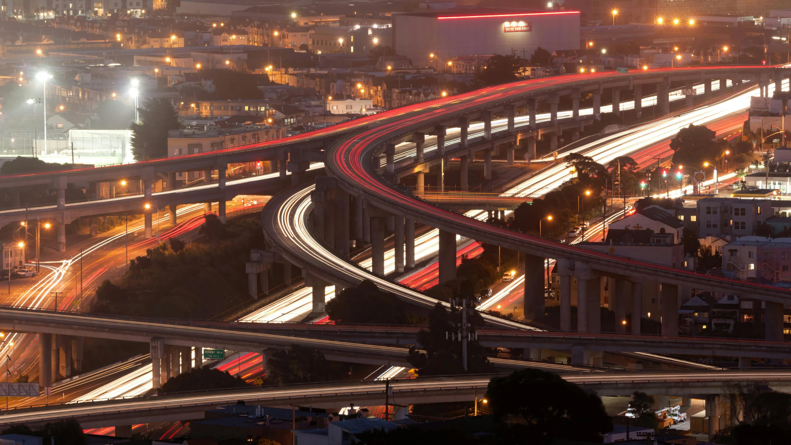 a street at night is lit with lights and a set of freeways