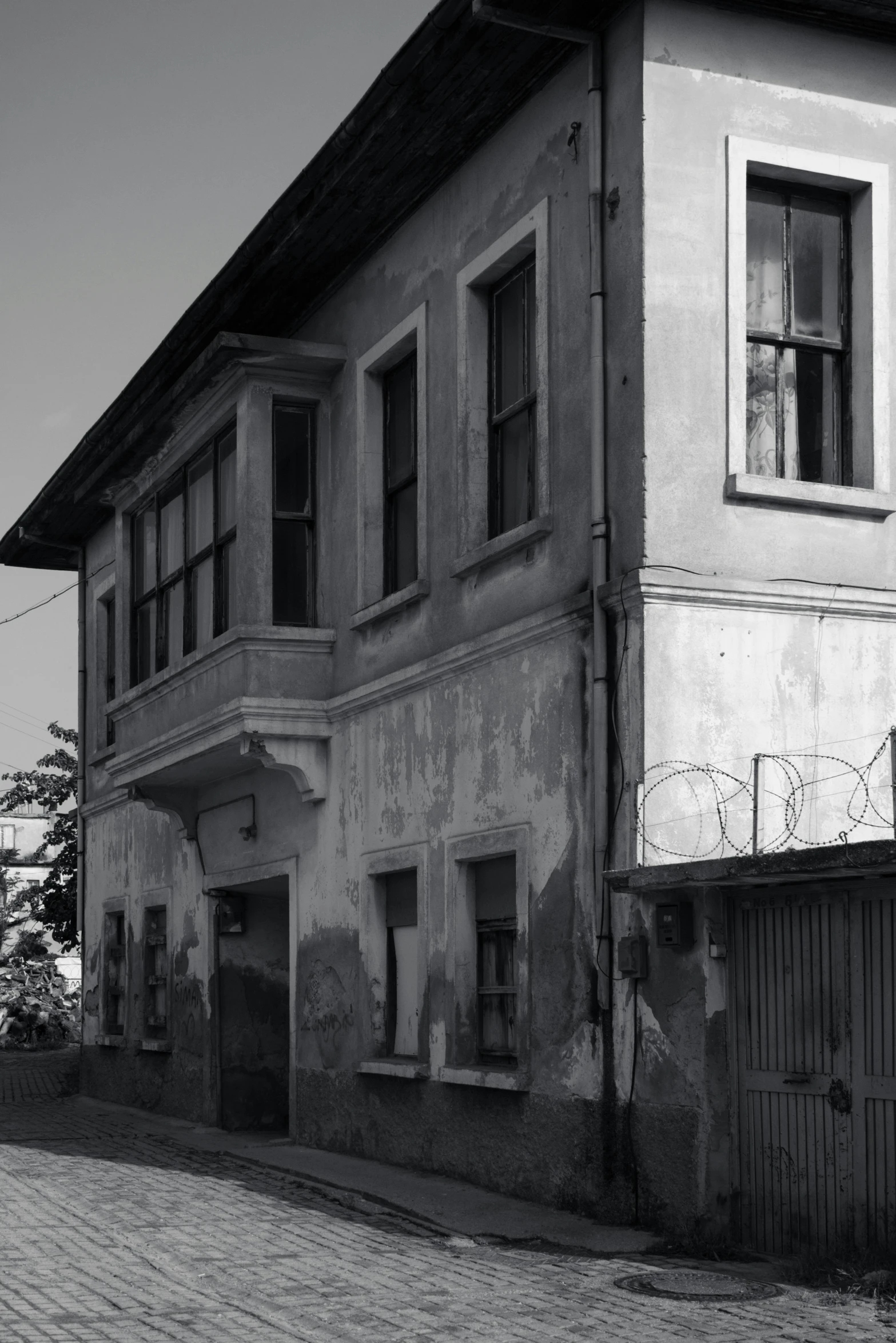 an old house with a bicycle next to it