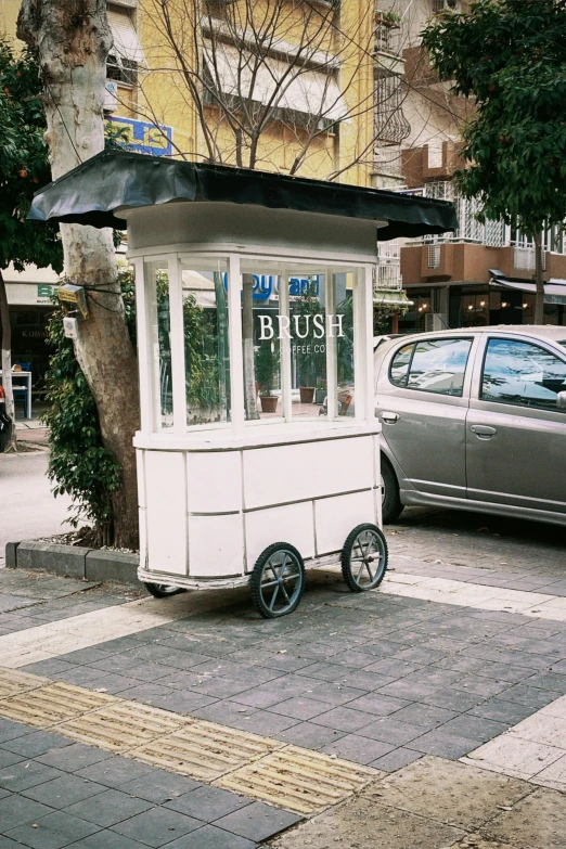 a covered bus stop is displayed with a vehicle