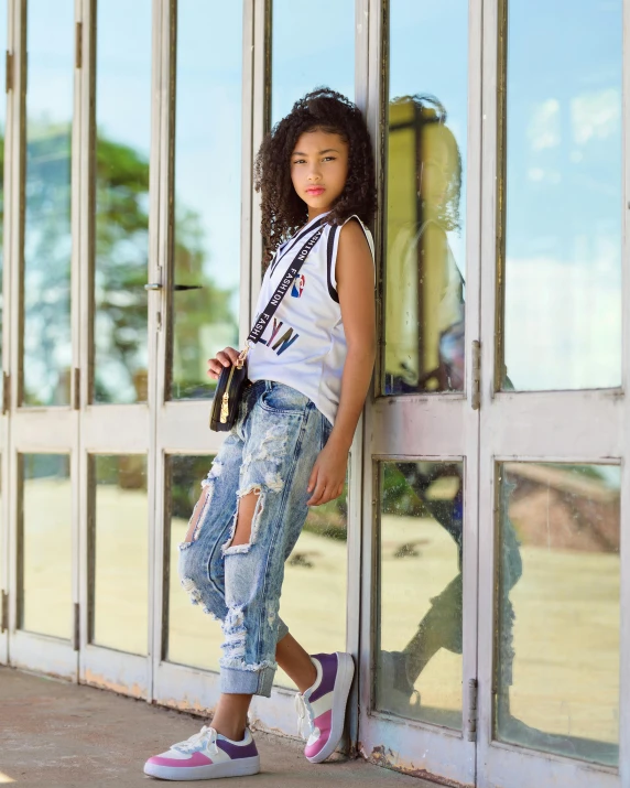 a girl leaning against a window looking sad and serious