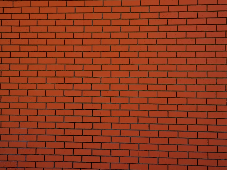 a red brick wall with a yellow fire hydrant