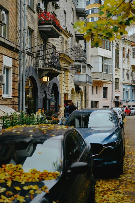 cars parked on the side of a road in a city