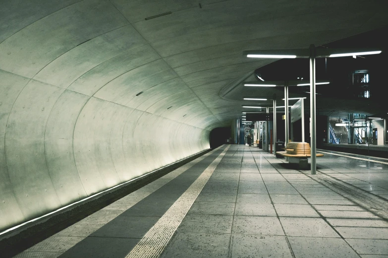 a hallway leading to a subway in the night