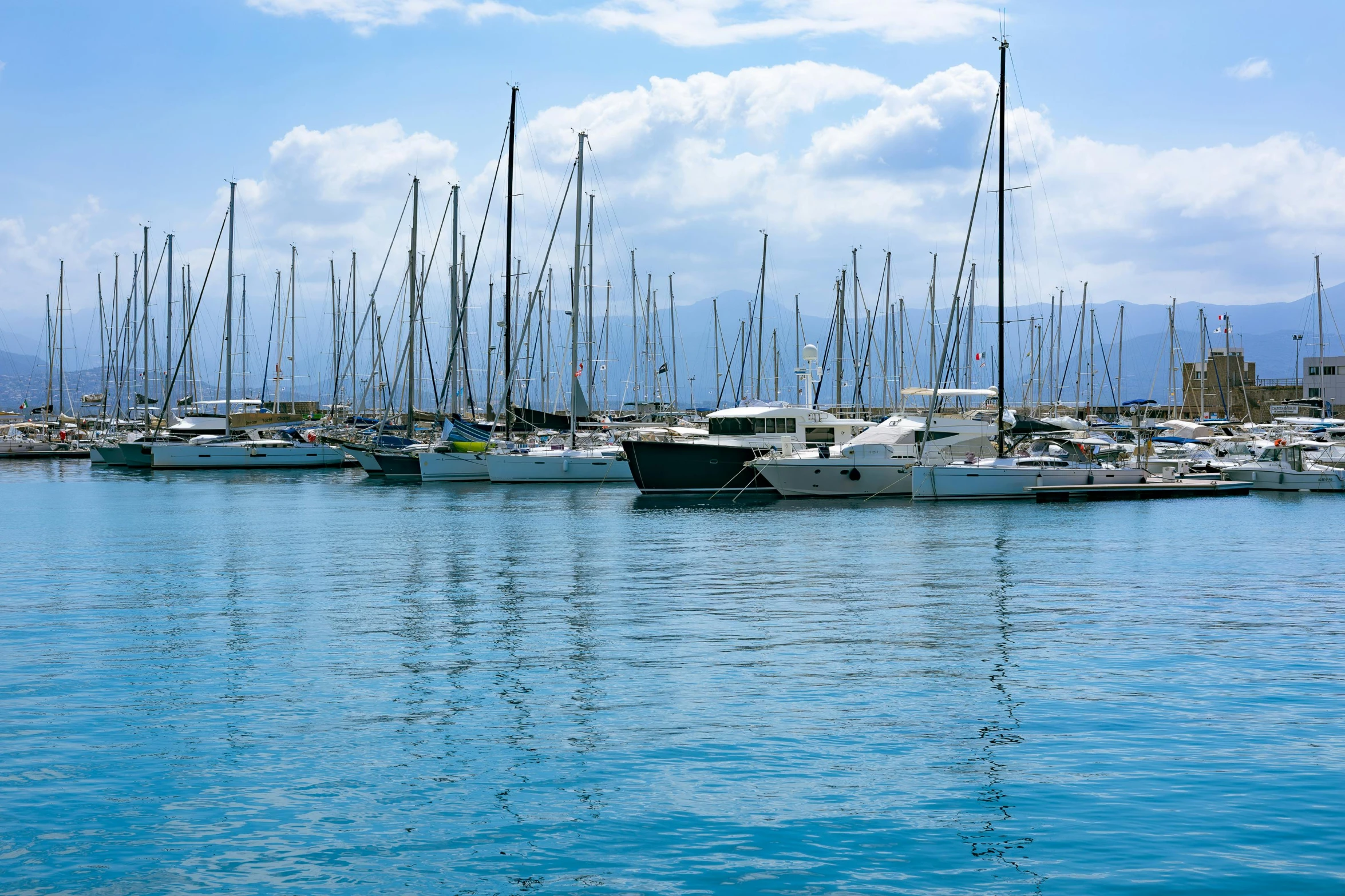 many sail boats are docked in the water