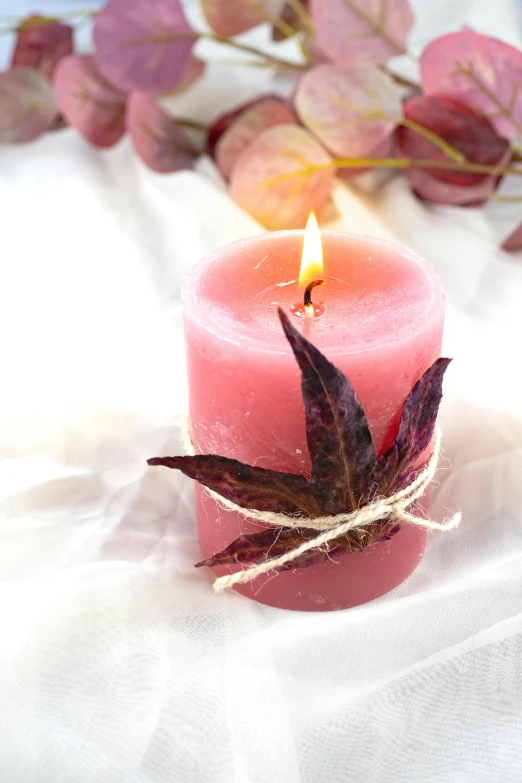 a pink candle sits beside a small purple candle