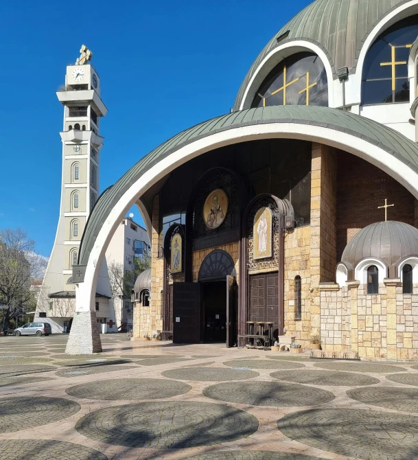 the entrance to an old church, with a clock tower