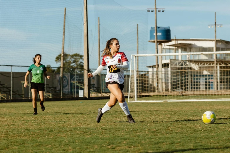 a group of young women on a field playing soccer