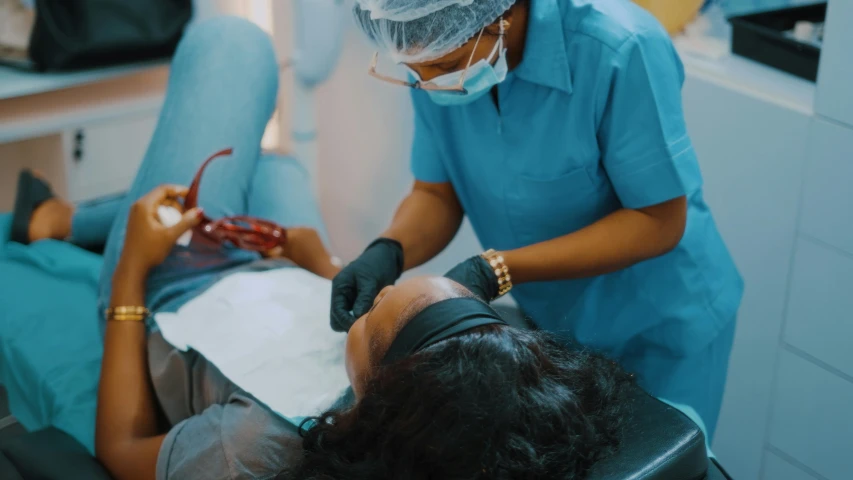 a woman gets a dental check up from an dentist