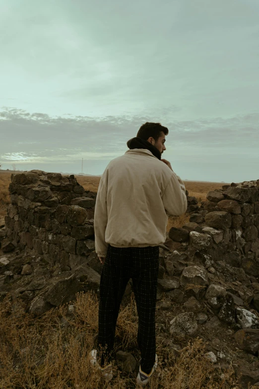 there is a man standing on rocks in the wilderness