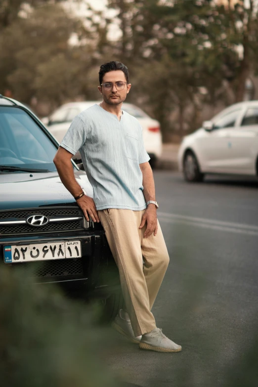 a man standing in front of a parked car