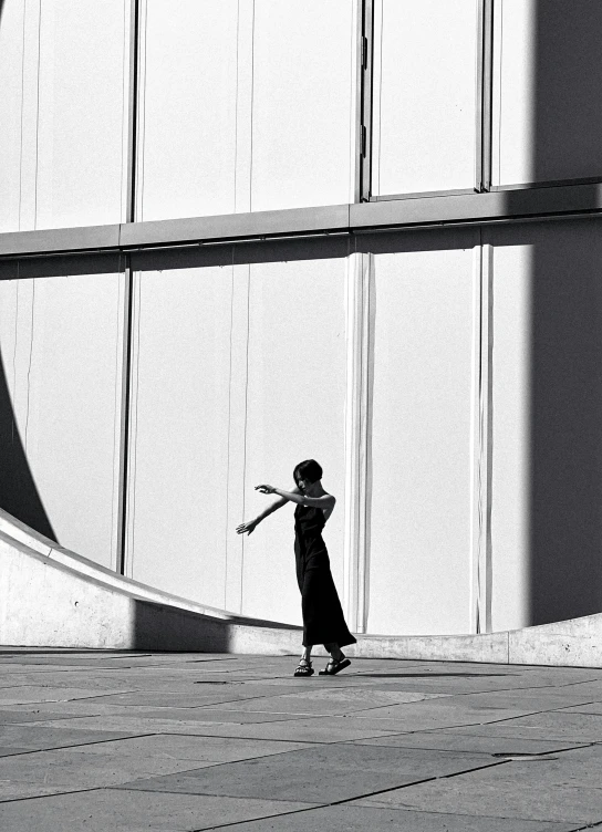 a woman that is standing in front of a wall