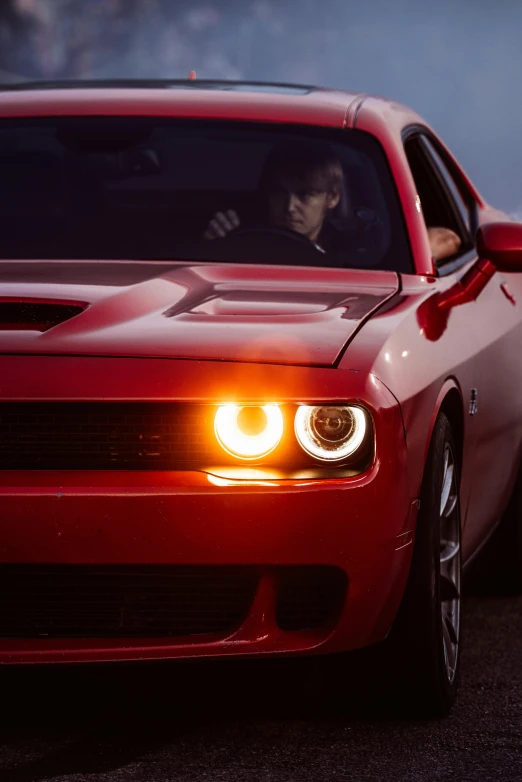 a red sports car driving in the road