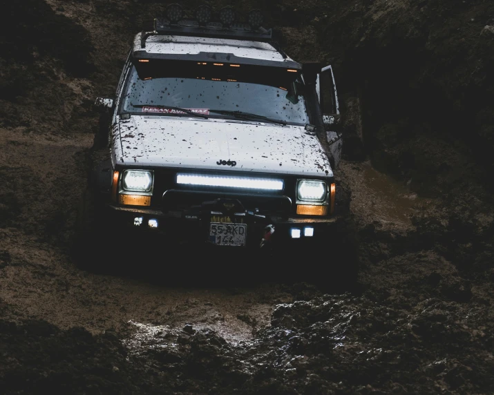 a white truck is driving through a stream