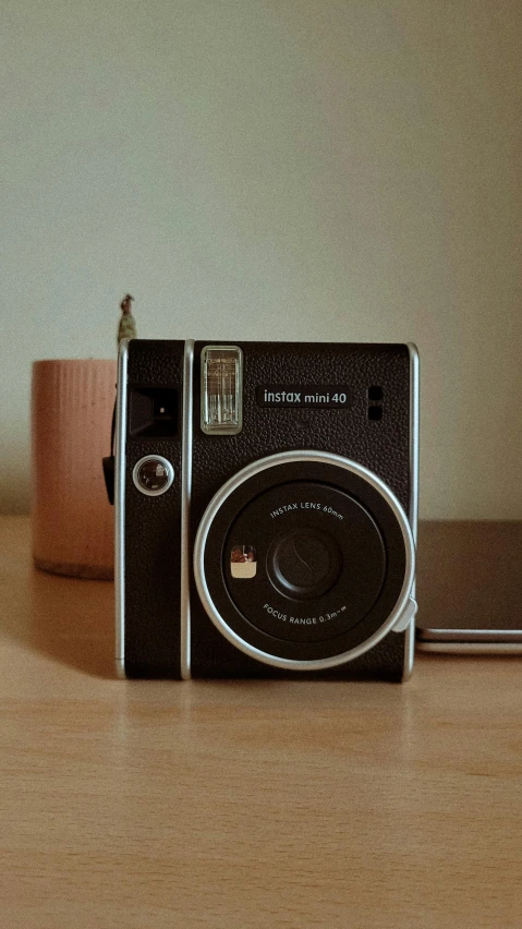 a black camera sitting on top of a wooden table