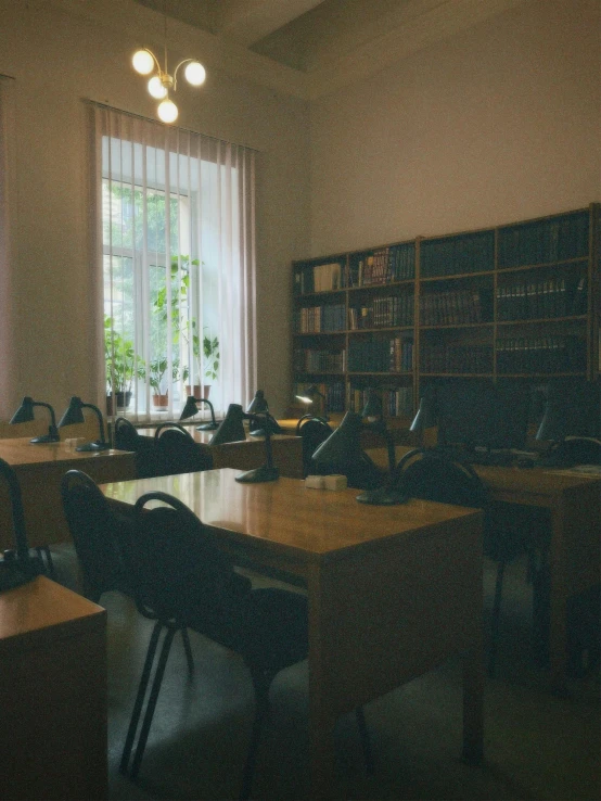 this is an old fashioned school room with tables and chairs