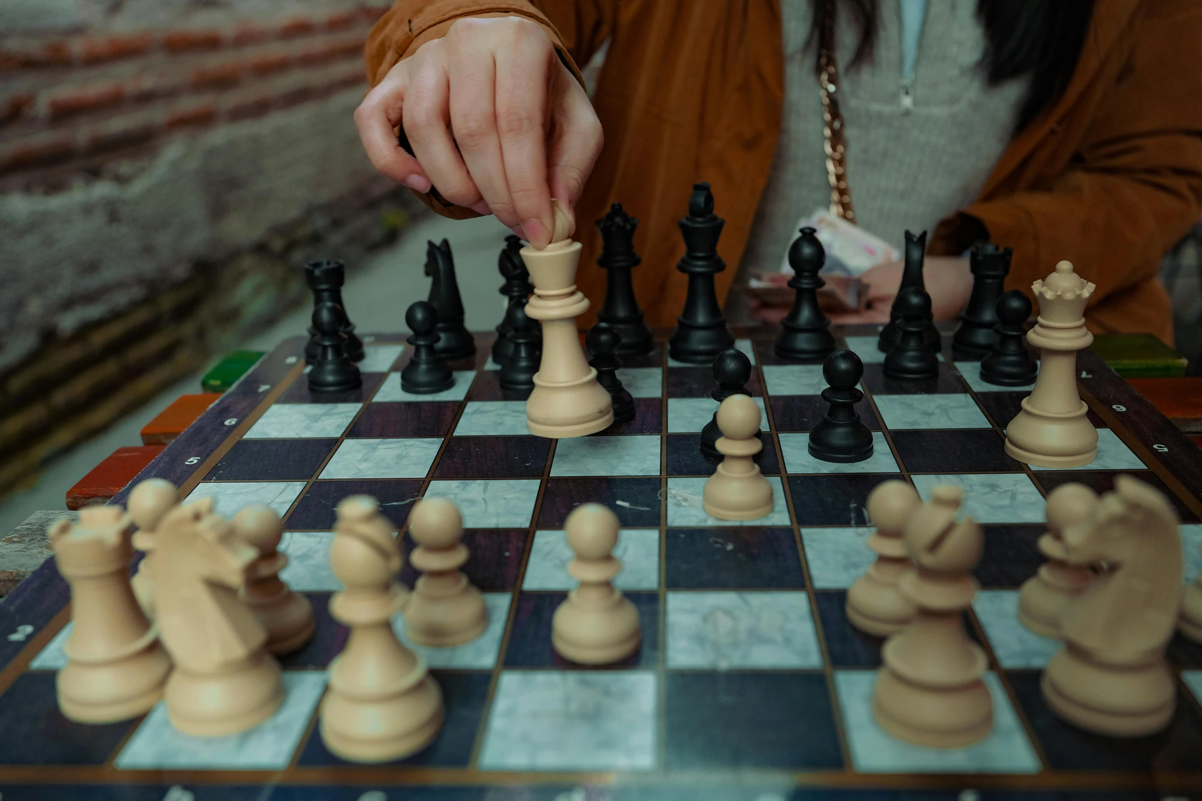 a lady is playing a game of chess