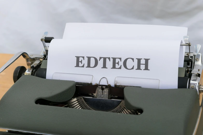 the words etc tech are shown on the paper next to an old typewriter