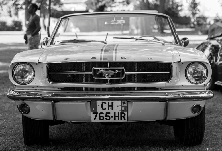 black and white pograph of an old mustang parked