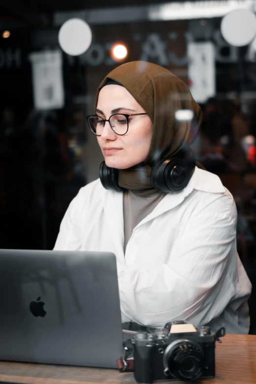 a woman in hijab using her laptop