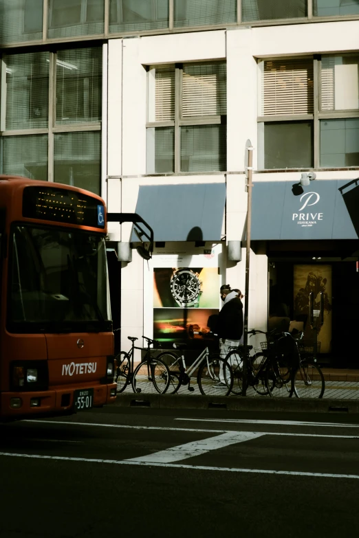 a bike leans against a bus on a street