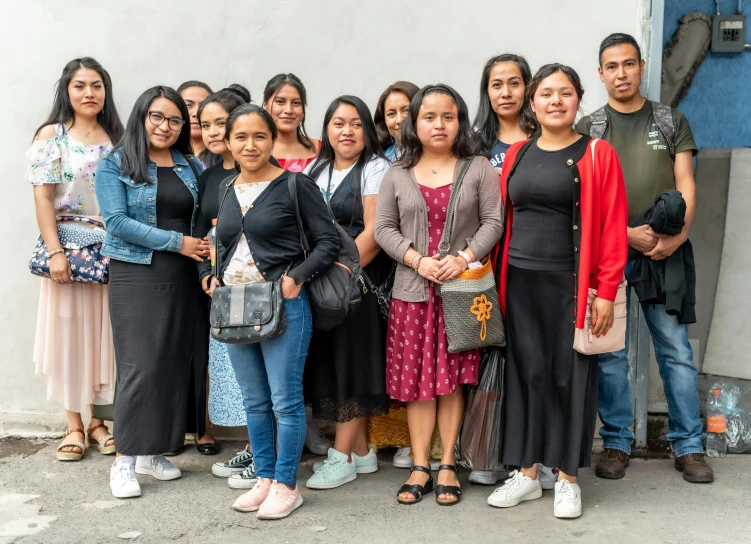 a group of women standing in front of a building