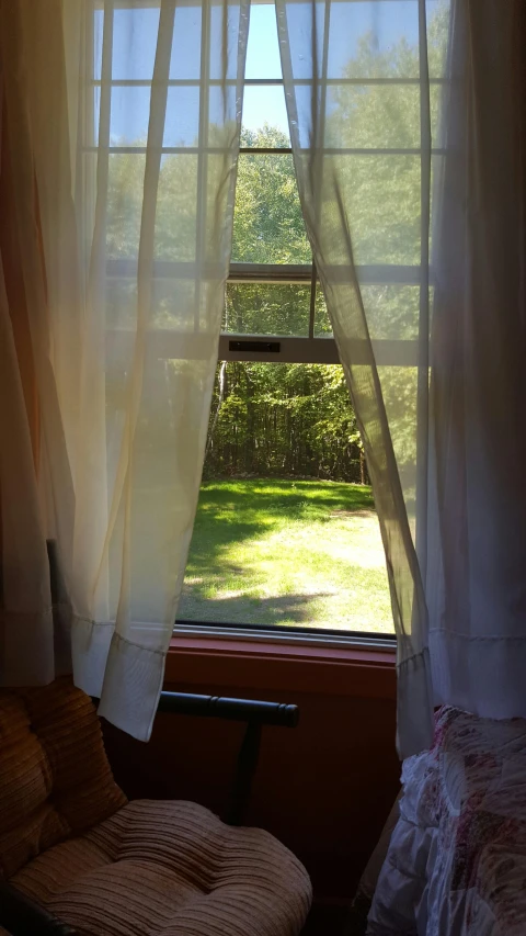 a window with a curtain that is in the corner