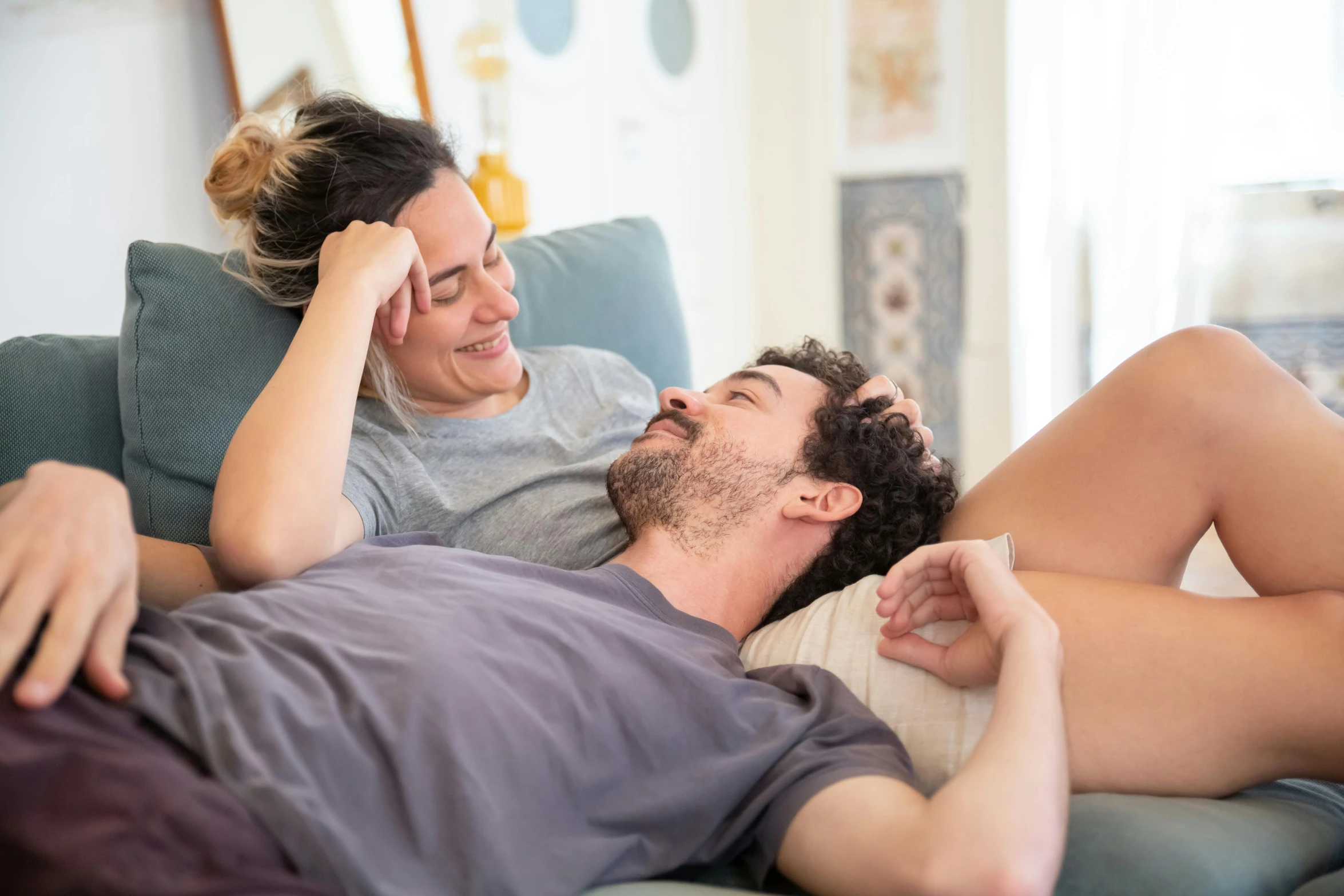 there is a woman laying on a man that has fallen over