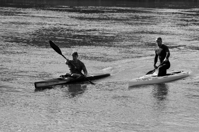 two people in kayaks are paddling on the water