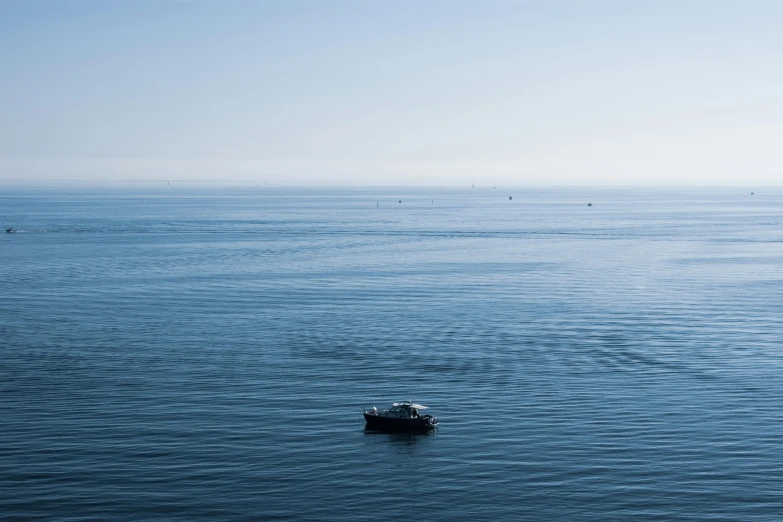 the small boat is out on the open water