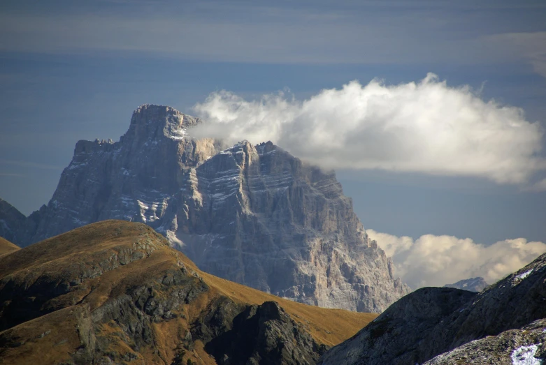 a couple of very big mountain tops with some clouds above