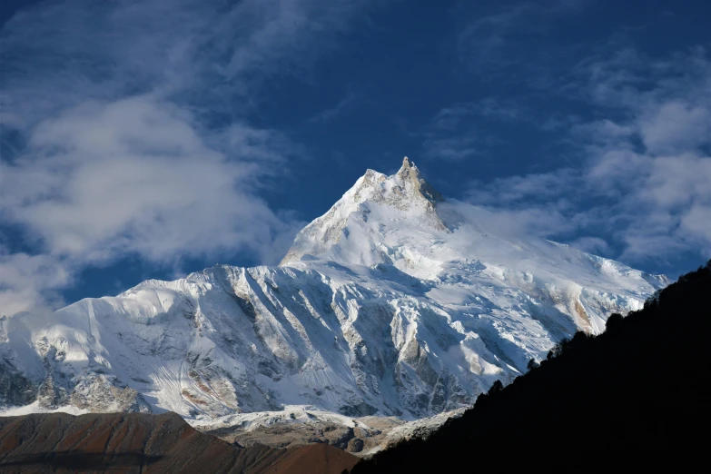 a mountain view with a large snow covered top