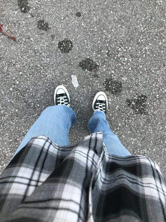 feet with shoes wearing sneakers with jeans on