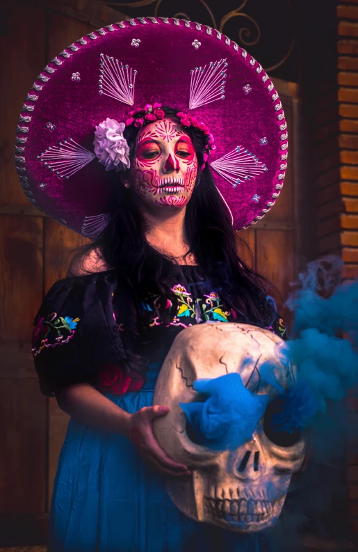 a woman with skull makeup holding a sugar skull