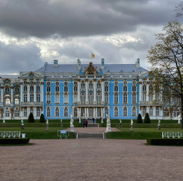 a building with a clock on it next to a tree