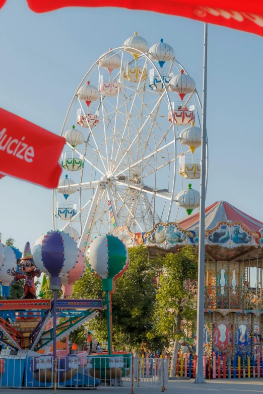 carnival with ferris wheel and flags waving at once