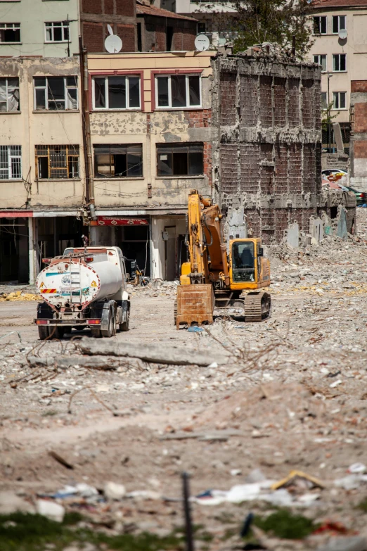 construction in front of a damaged building with broken windows