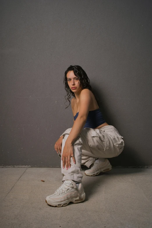 a woman crouching and touching her shoe