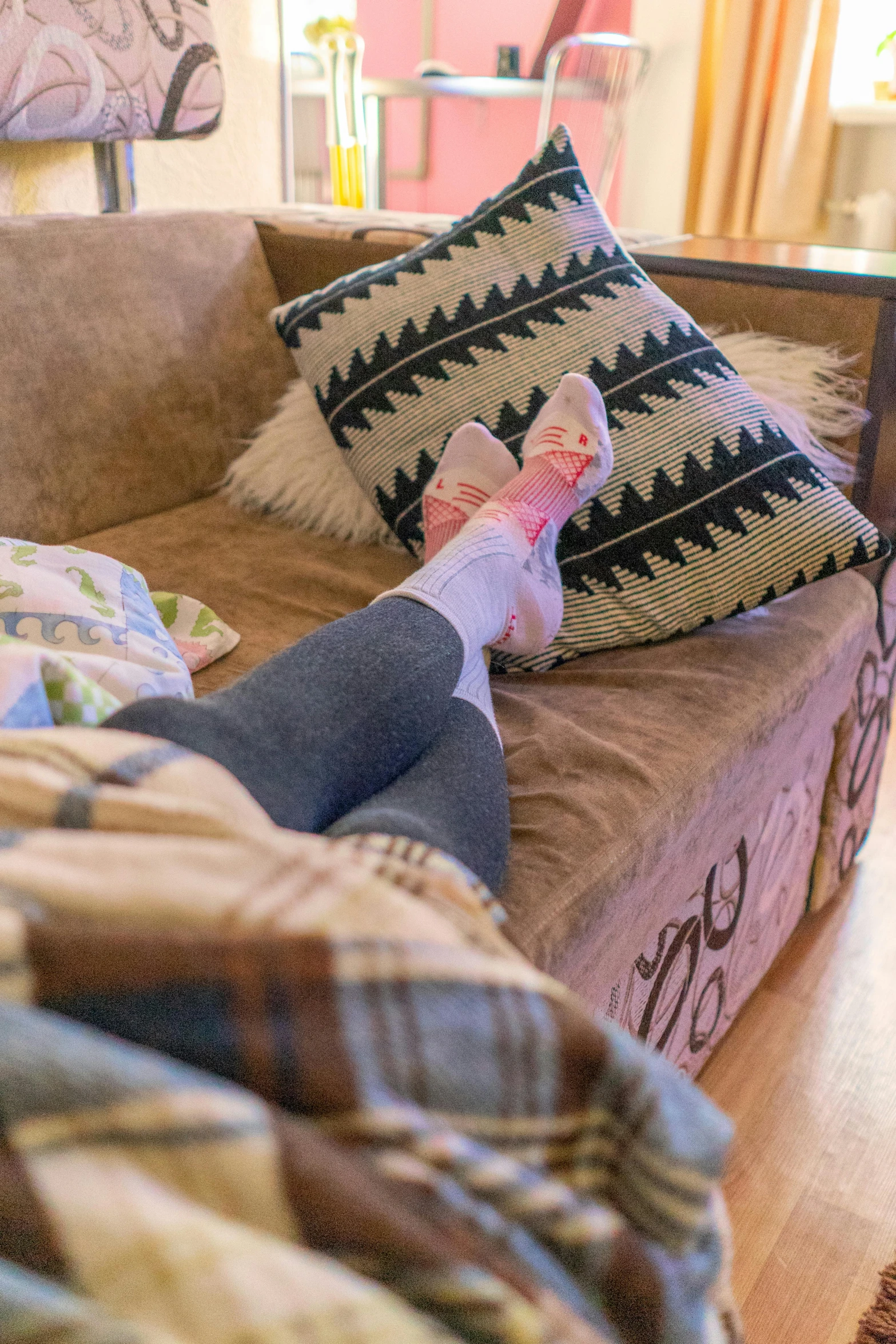 a person lays on the couch with their legs up