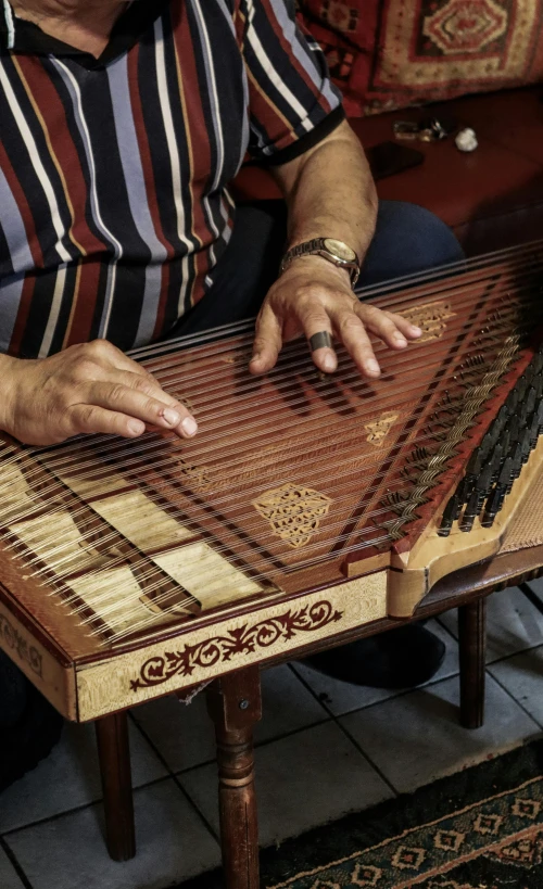 a person that is sitting down playing some type of instrument