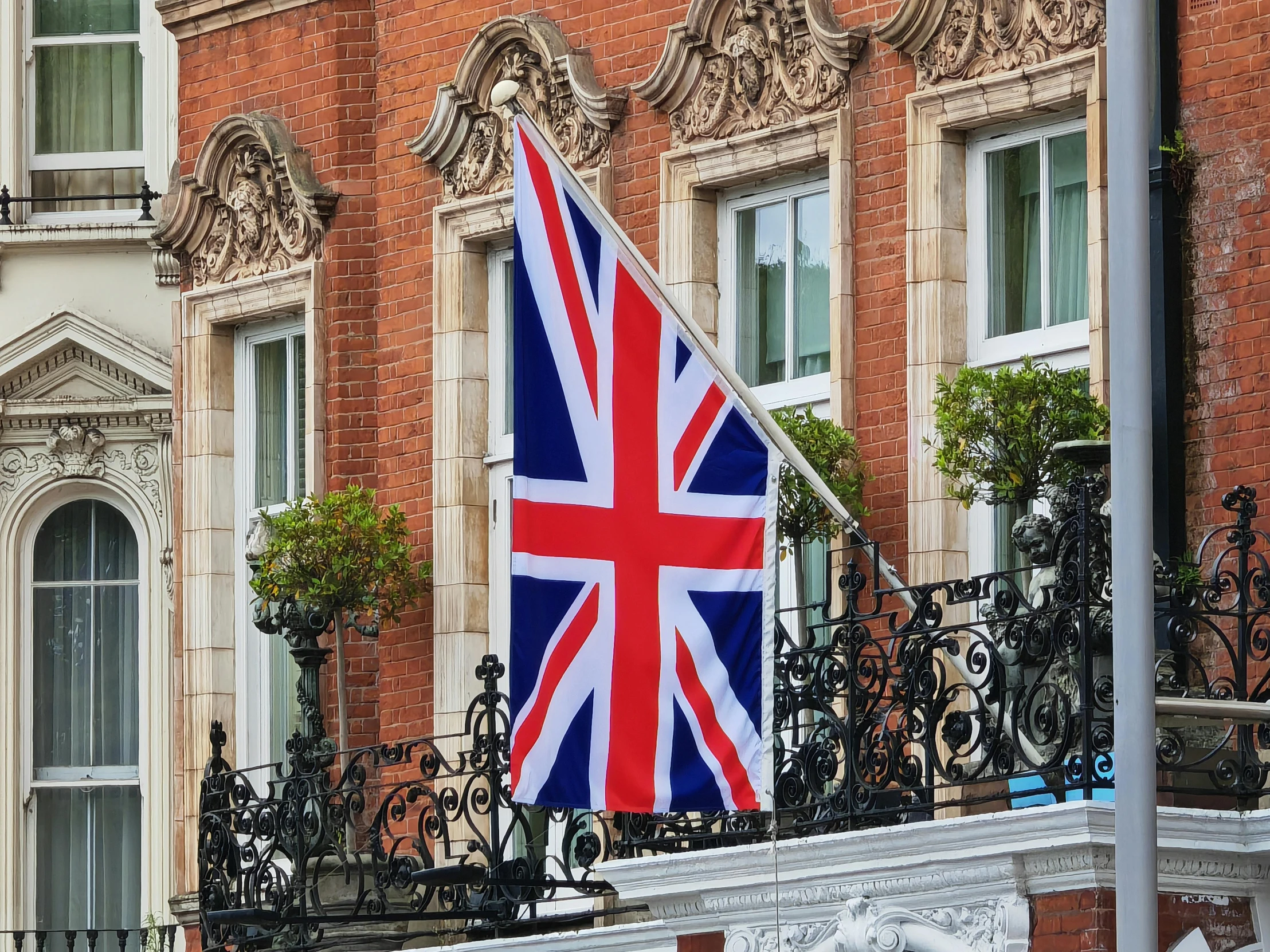 a union jack flag on a balcony of an apartment building