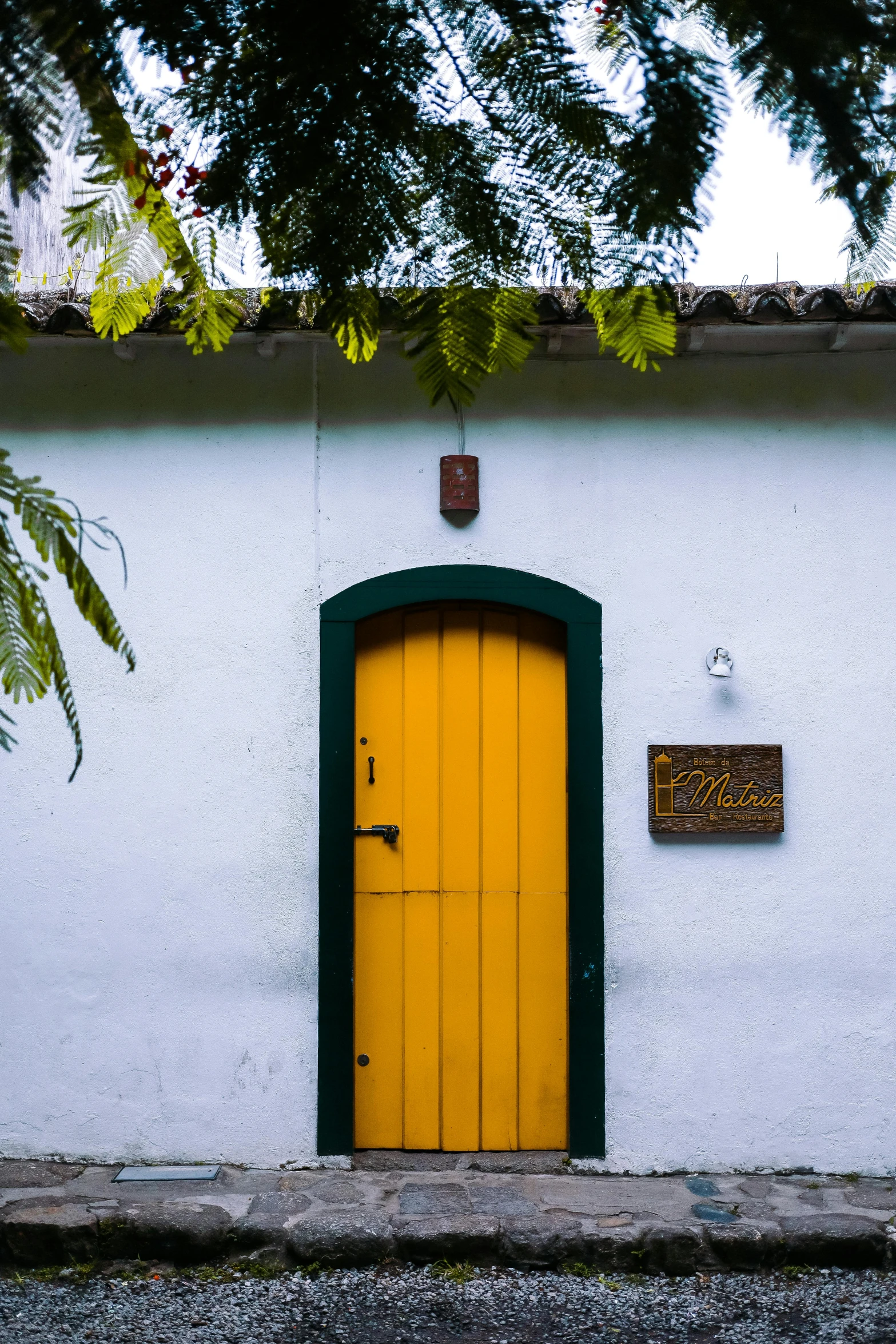 a yellow door sits behind a green doorway