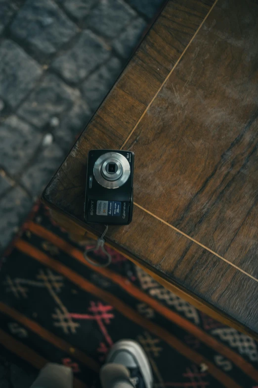 a small camera sits on the wooden floor