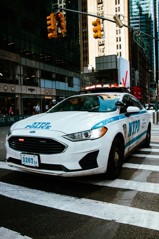 a police car is stopped at an intersection