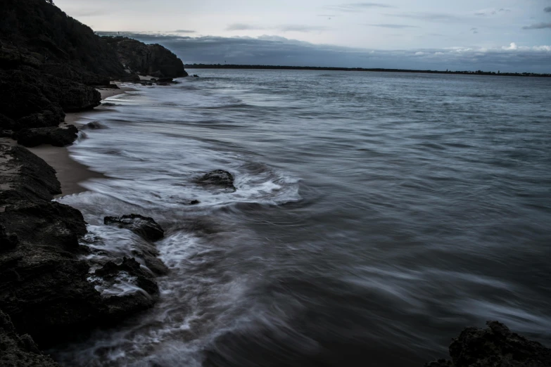 the rocky shore with a body of water