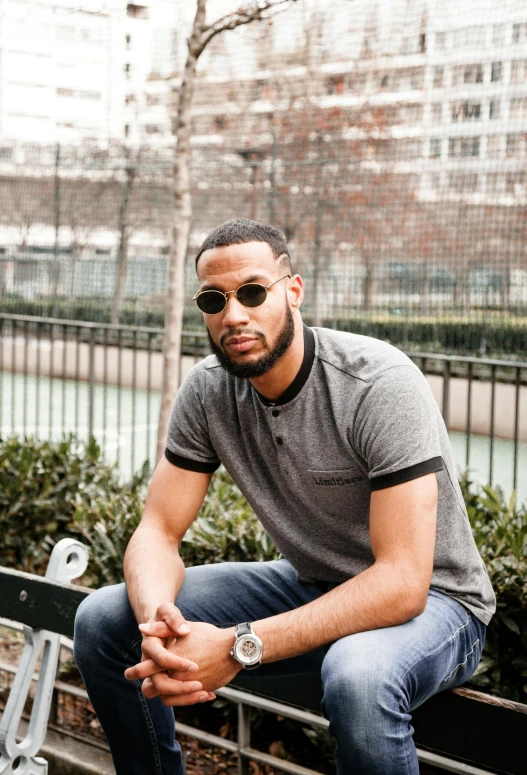 a man sitting on a bench wearing sunglasses