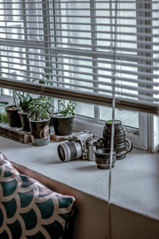 a camera is sitting on the ledge of a window sill