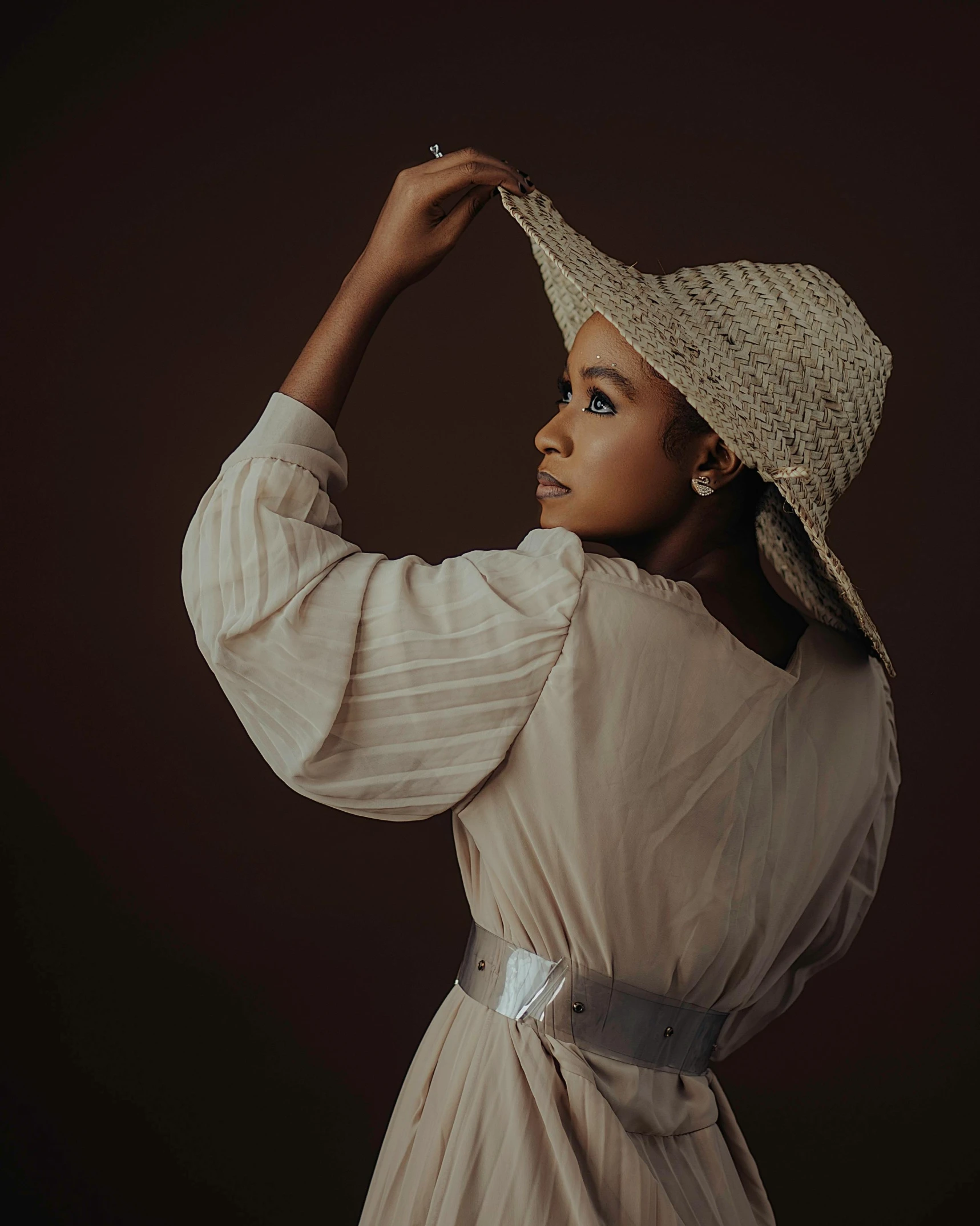 a beautiful woman in a hat is shown