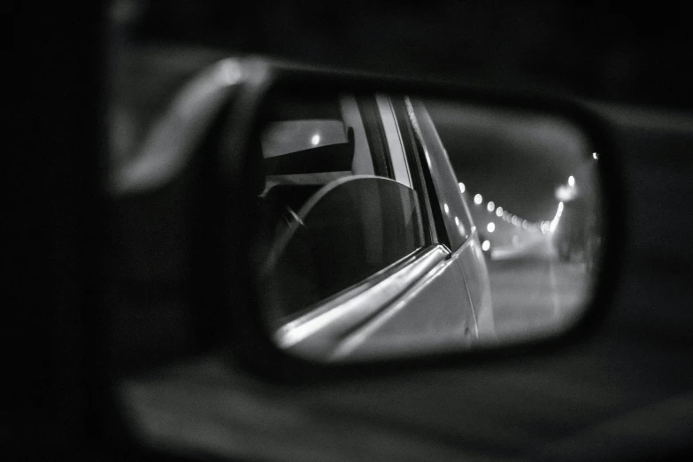 the rear view mirror of a car on a road