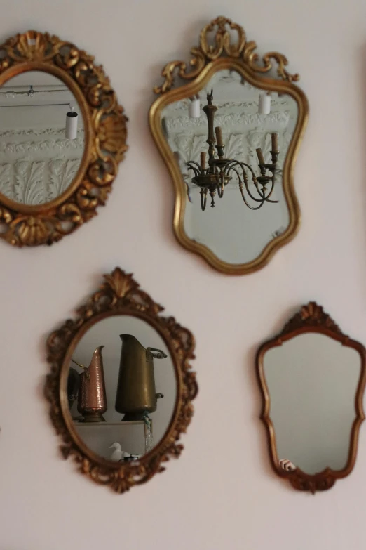 gold mirrors and candles displayed on the wall